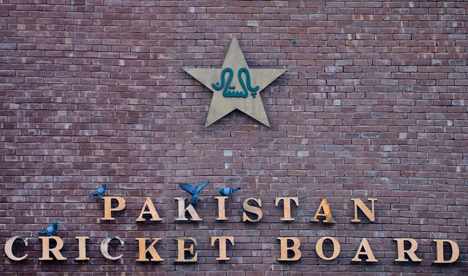 This picture taken on September 7, 2017 shows pigeons resting on a sign for the Pakistan Cricket Board at the Gaddafi Stadium in Lahore. (AFP/File)