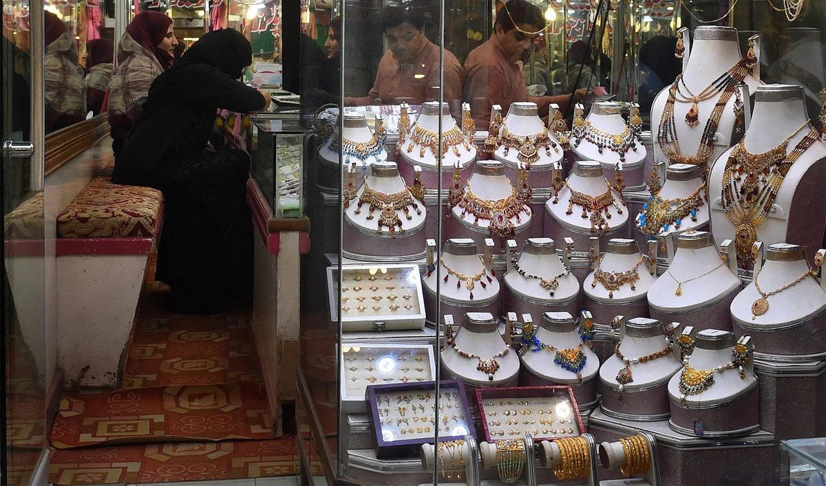 Pakistani women check gold jewellery at a shop in Lahore on October 11, 2018. (AFP/File)