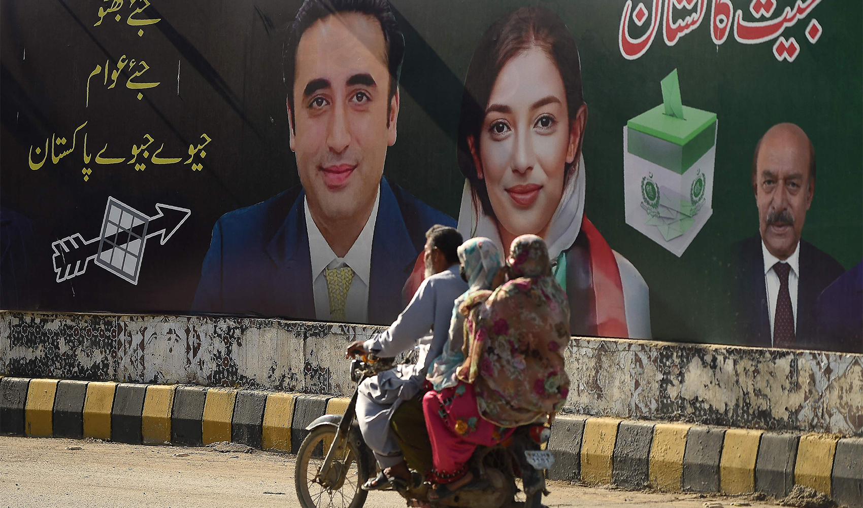 Commuters ride past an election campaign poster of the Pakistan Peoples Party (PPP) in Karachi on January 31, 2024, ahead of Pakistan's upcoming general elections. (AFP)