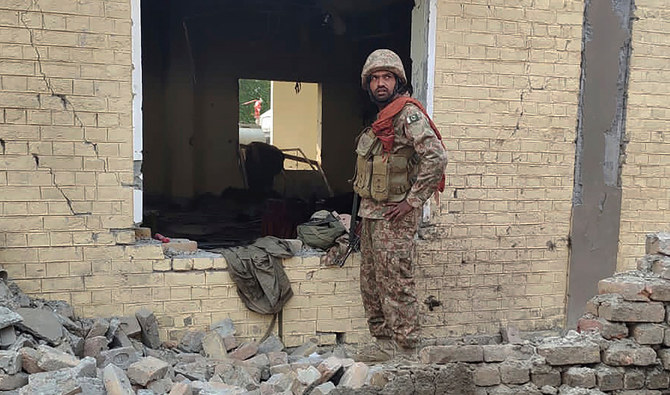An army soldier examines damages on the site of a bombing at a police station on the outskirts of Dera Ismail Khan, Pakistan, on December 12, 2023. (AP/File)