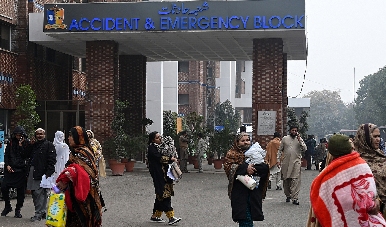 People walk at the Children's Hospital in Lahore on January 31, 2024. In a Pakistan paediatric ward a chorus of infant coughs and straining lungs is the toll of a frigid winter, compounded by choking smog and lagging vaccination rates. (AFP)