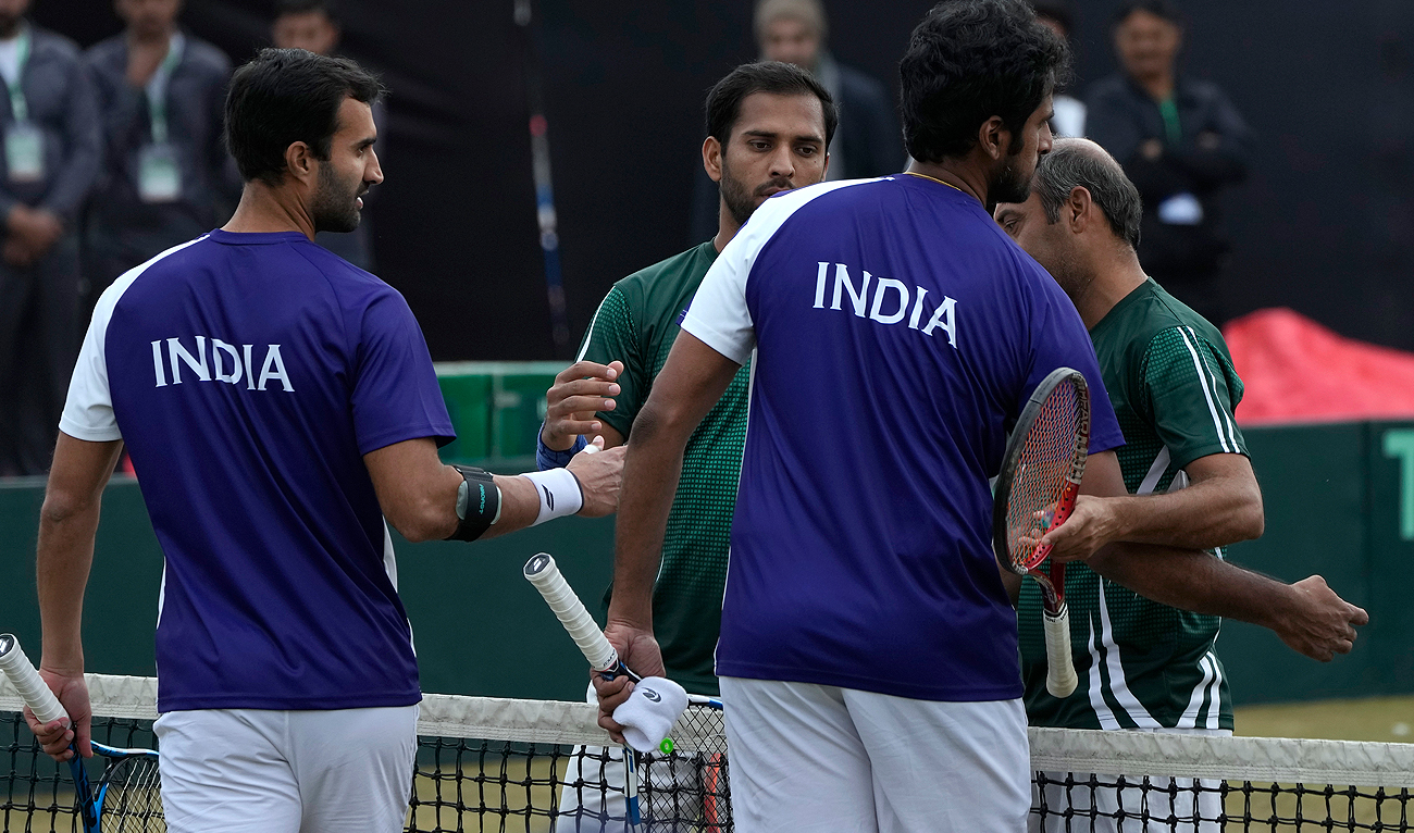 India's Yuki Bhambri, right, and teammate Saketh Myneni shake hands with Pakistan's Muzammil Murtaza, center, and Aqeel Khan on the end of their double match in the Davis Cup World Group I play-off tennis, in Islamabad on February 4, 2024. (AP)