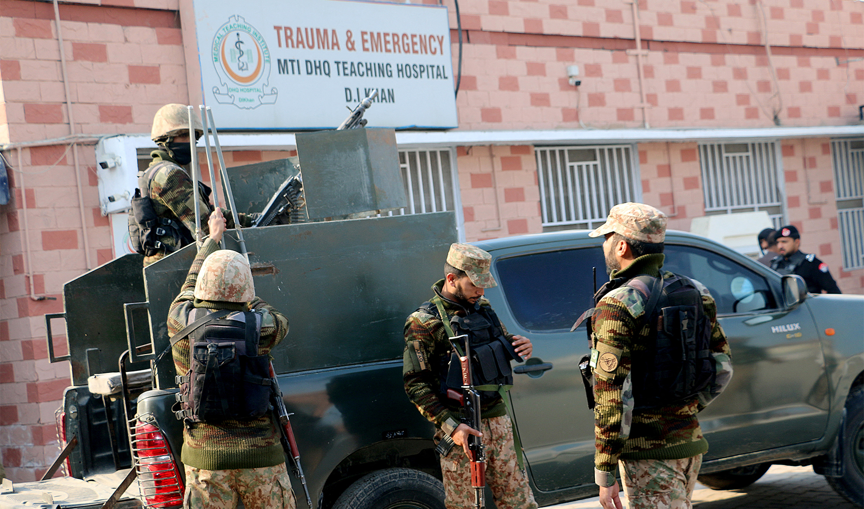 Security personnel stand guard outside a hospital where injured police officers are treated after a militant attack on a police station in Dera Ismail Khan, Pakistan, on February 5, 2024. (REUTERS)
