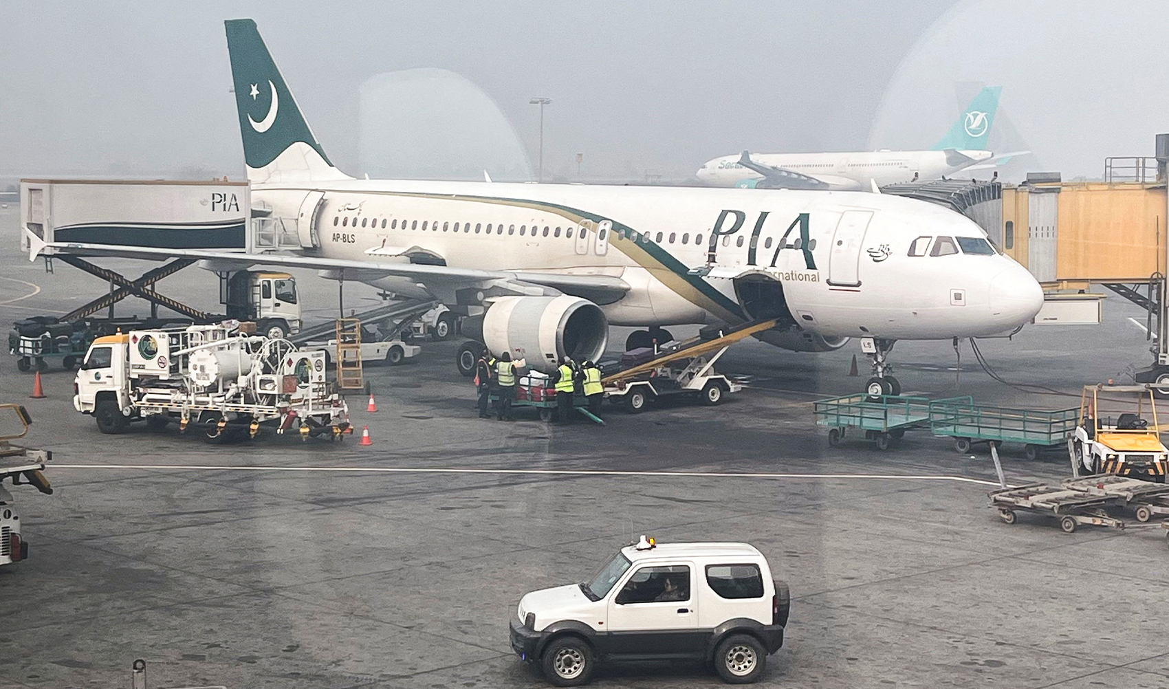iew of a Pakistan International Airlines (PIA) passengers plane, taken through a glass panel, at the Allama Iqbal International Airpor in Lahore, Pakistan on January 29, 2024. (REUTERS)