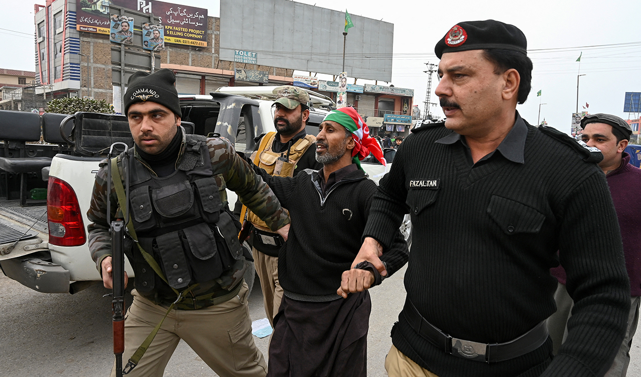 Police personnel detain a supporter of Pakistan Tehreek-e-Insaf (PTI) party during a protest demanding the release of PTI leader Imran Khan, in Peshawar on January 28, 2024. (AFP/File)
