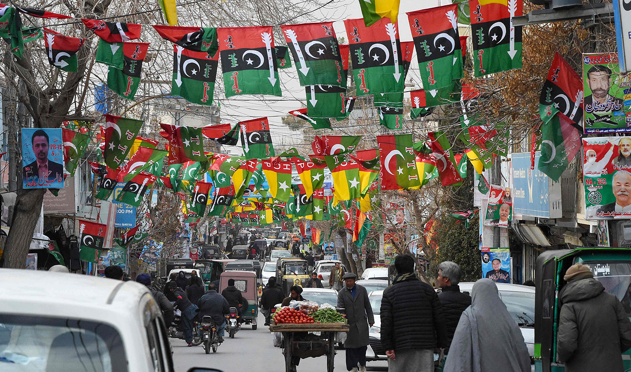 This photo taken on February 3, 2024, shows a street festooned with flags of political parties ahead of Pakistan's national elections, in Quetta. (AFP)