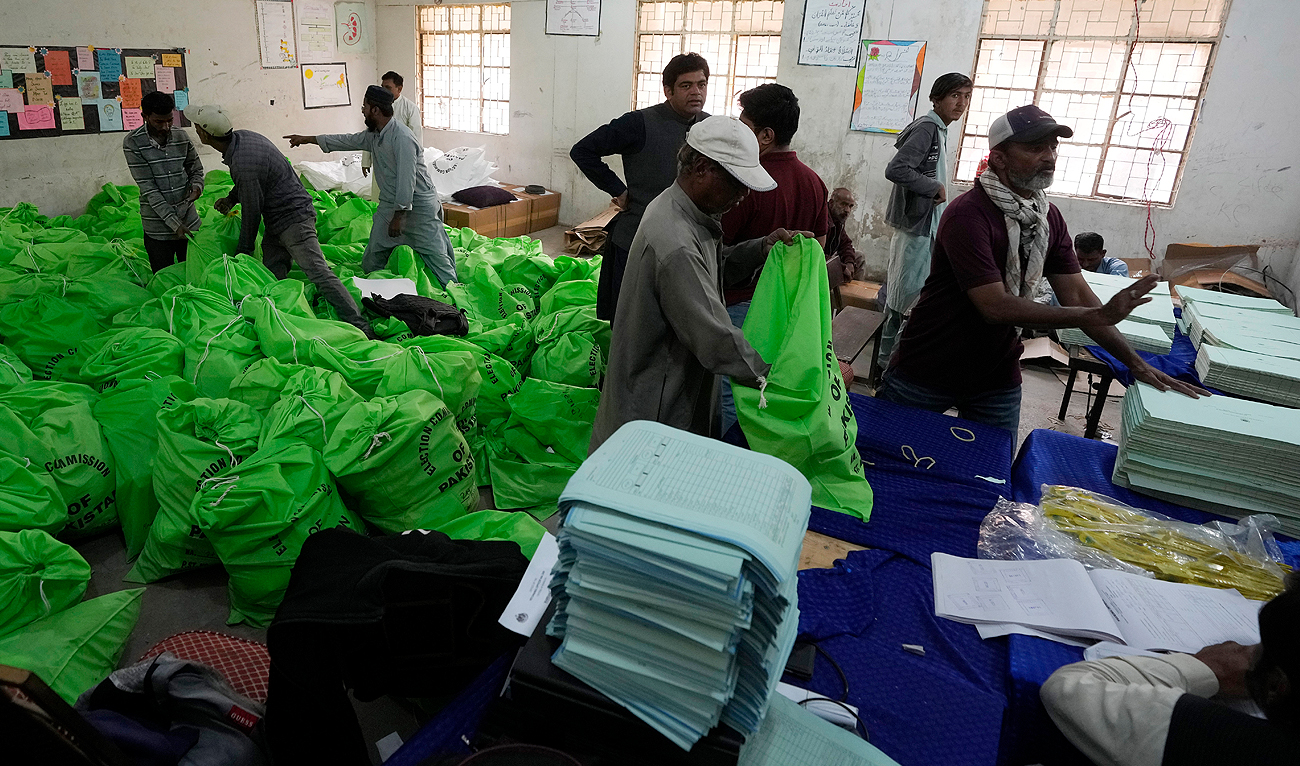 Workers pack bags with election materials, which will be handed over to polling staff for upcoming Feb. 8 general election, at an election commission office in Karachi on February 6, 2024. (AP)