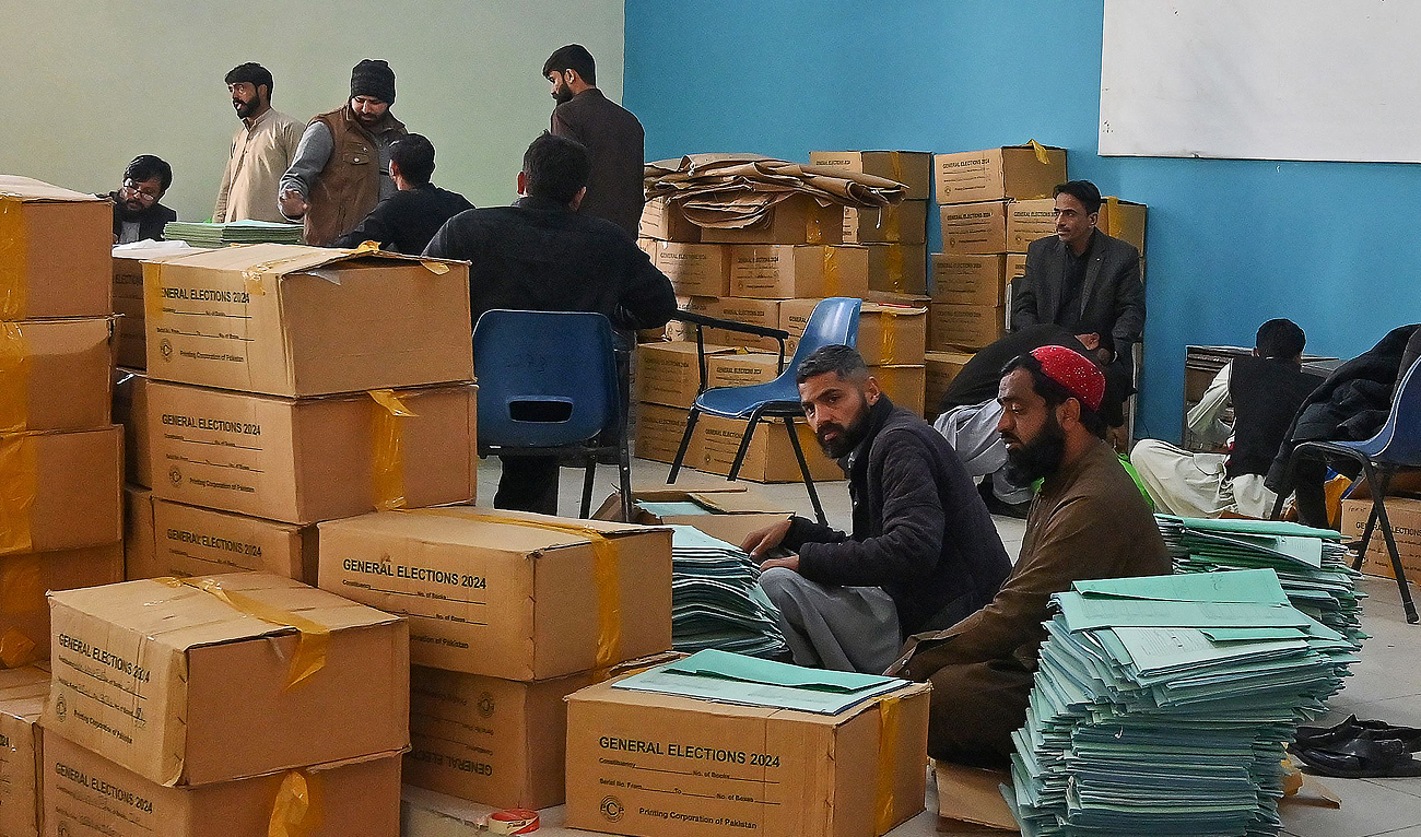 Workers preapre voting materials at a distributing centre in Islamabad on February 6, 2024, ahead of Pakistan's general election. (AFP)
