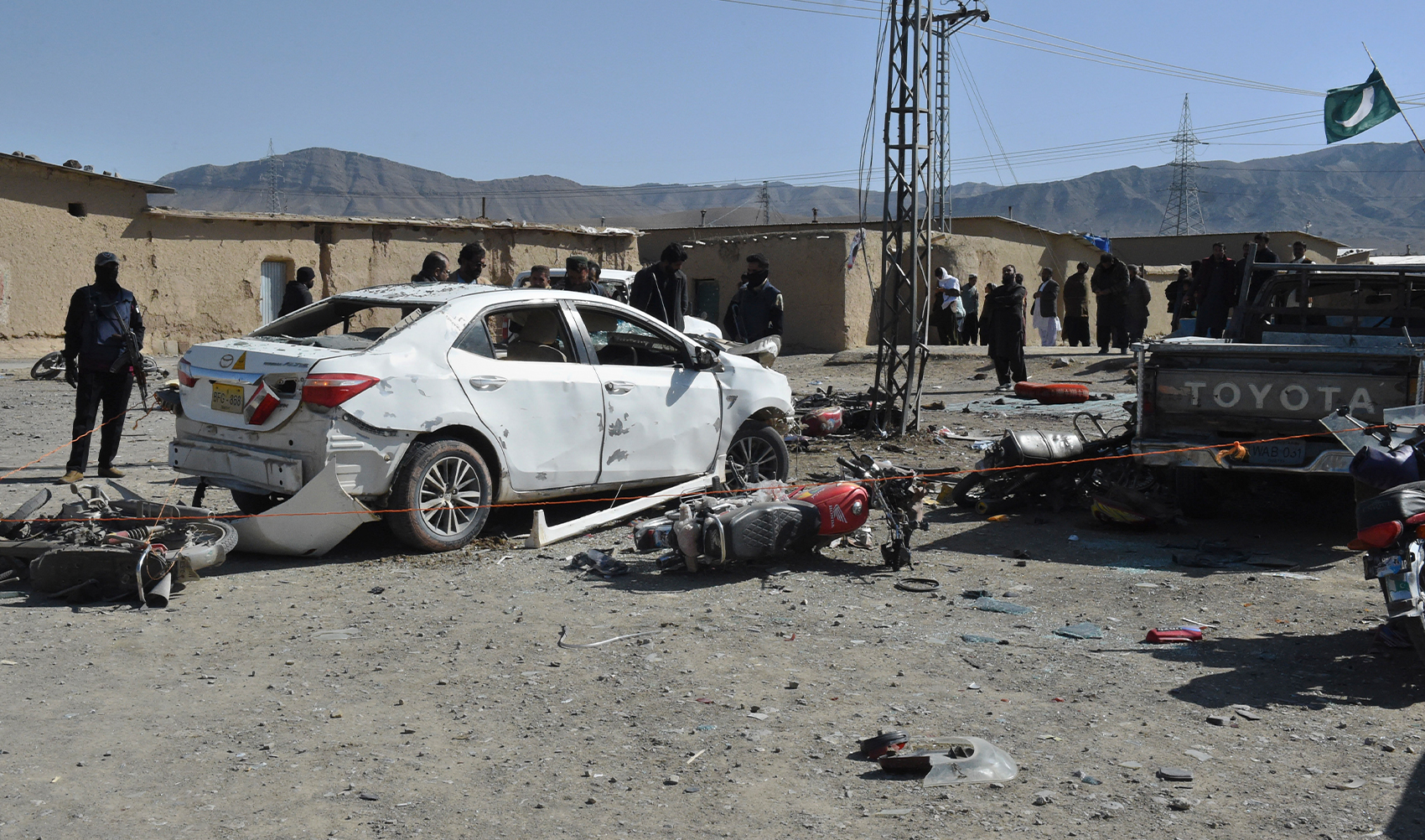 Security officials examine the site of bomb blast in Khanozai, Pashin, a district of Pakistan's Baluchistan province, on February 7, 2024. (AP)