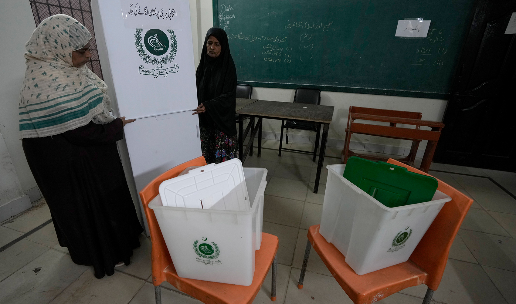 Members of the polling staff set up a polling station in a school building for the Feb. 8 parliamentary elections, in Karachi, Pakistan, on Feb. 7, 2024. (AP)