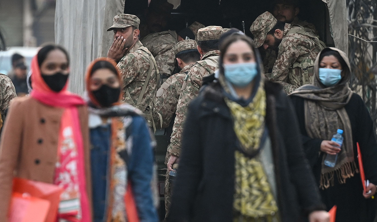 A Pakistan army personnel watches as election officials arrive at a polling station before the start of voting in Pakistan's national elections in Lahore on February 8, 2024. (AFP)