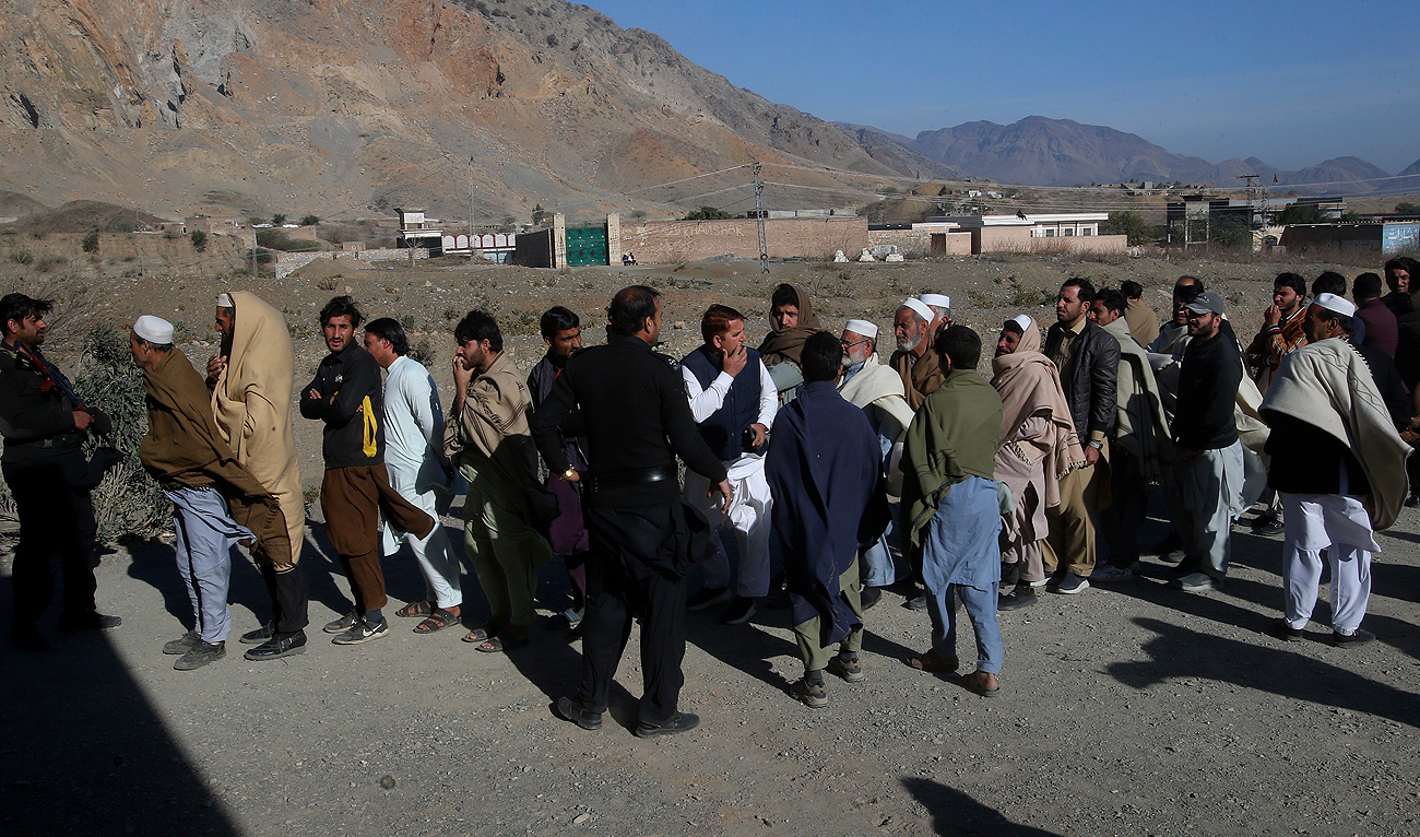 People stand in queue as they wait for their turn to cast vote outside a polling station during the country's parliamentary elections in Jamrud, in the Khyber district, Pakistan on February 8, 2024. (AP)