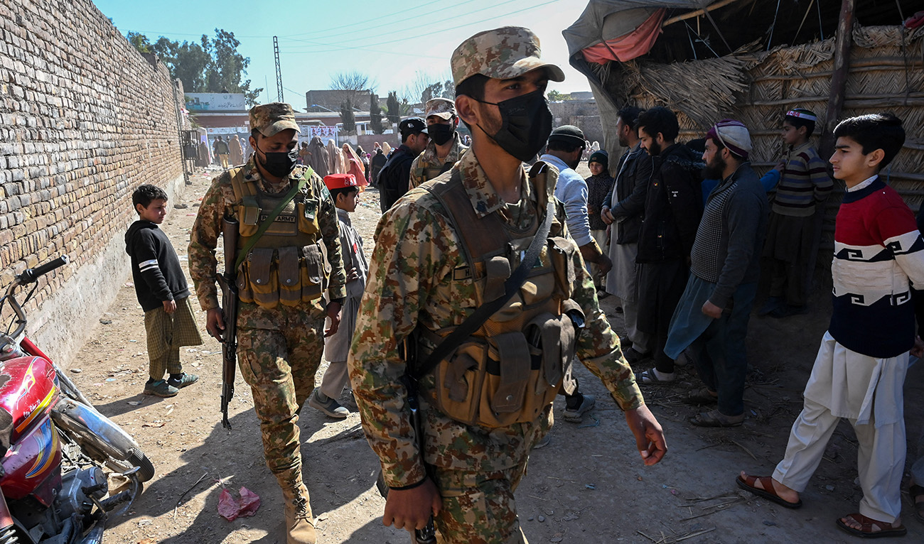 Pakistani army personnel patrol outside a polling station during Pakistan's national elections in Peshawar on February 8, 2024. (AFP)