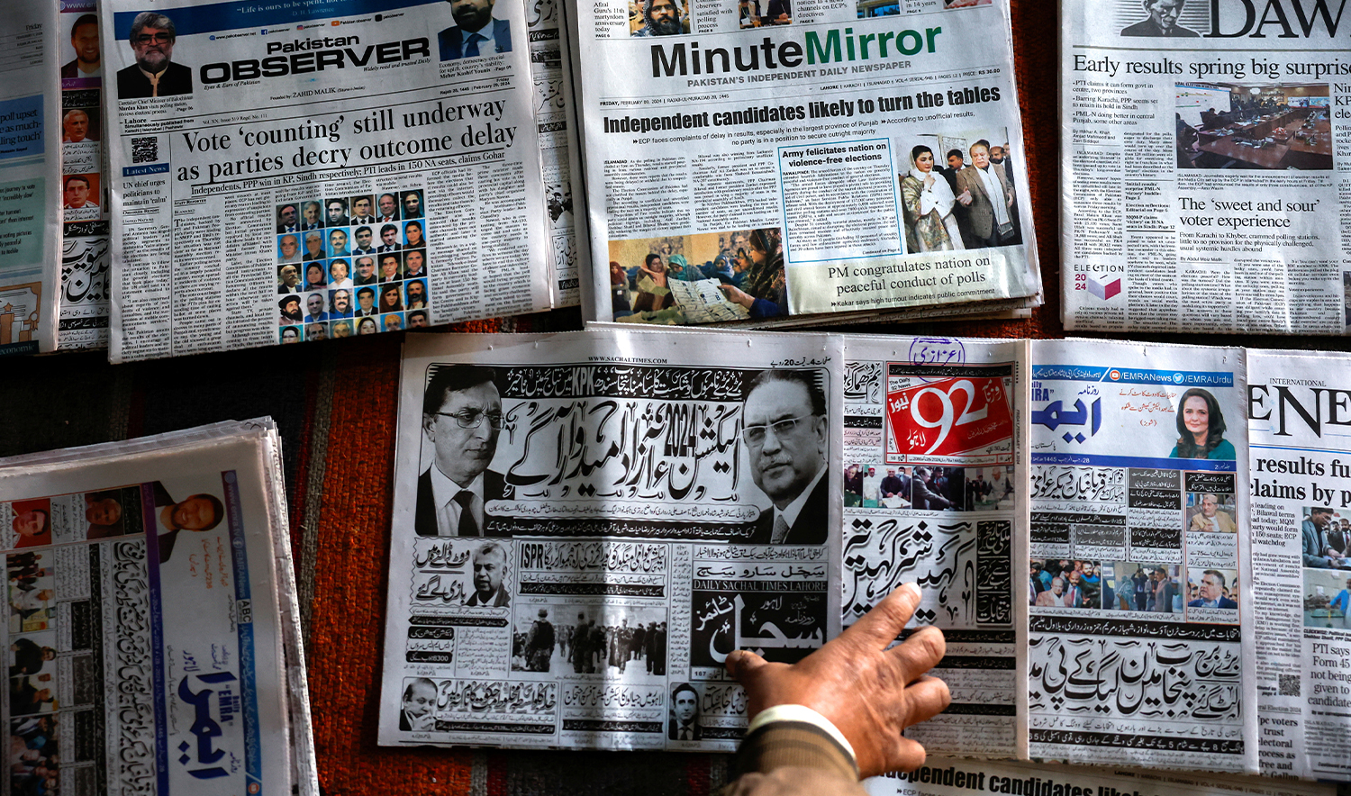 A vendor arranges newspapers at his stall, a day after the general election, in Lahore, Pakistan, on February 9, 2024. (REUTERS)