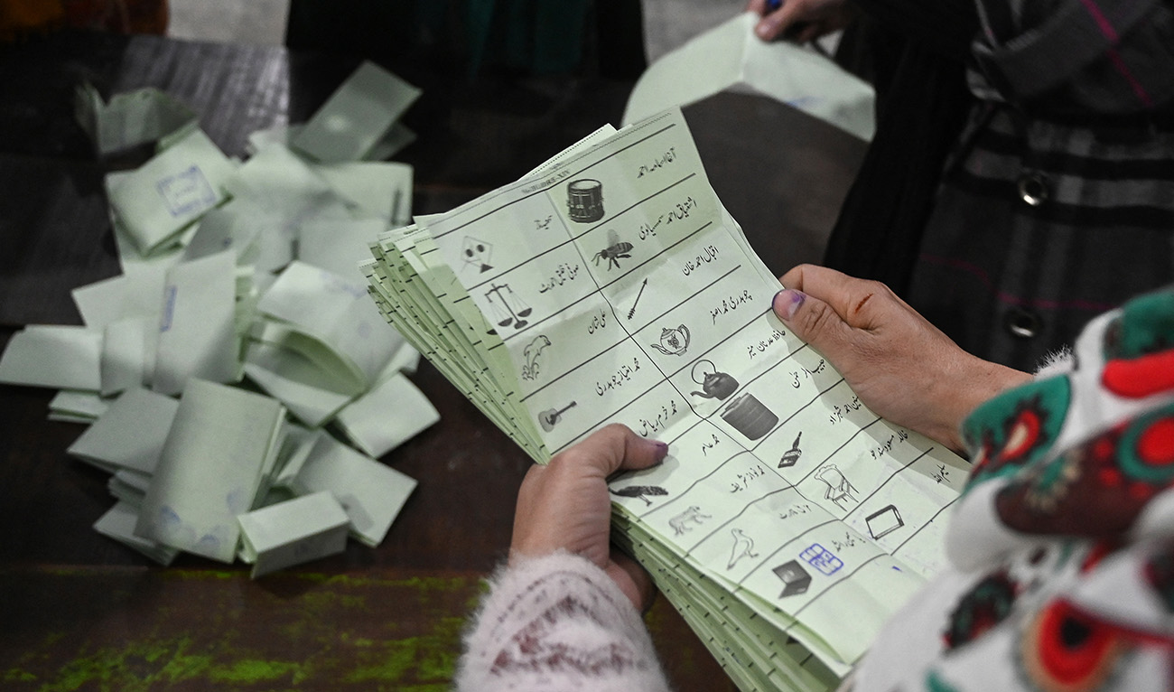 Election officials count ballot papers after polls closed at a polling station during Pakistan national election in Lahore on February 8, 2024. (AFP)
