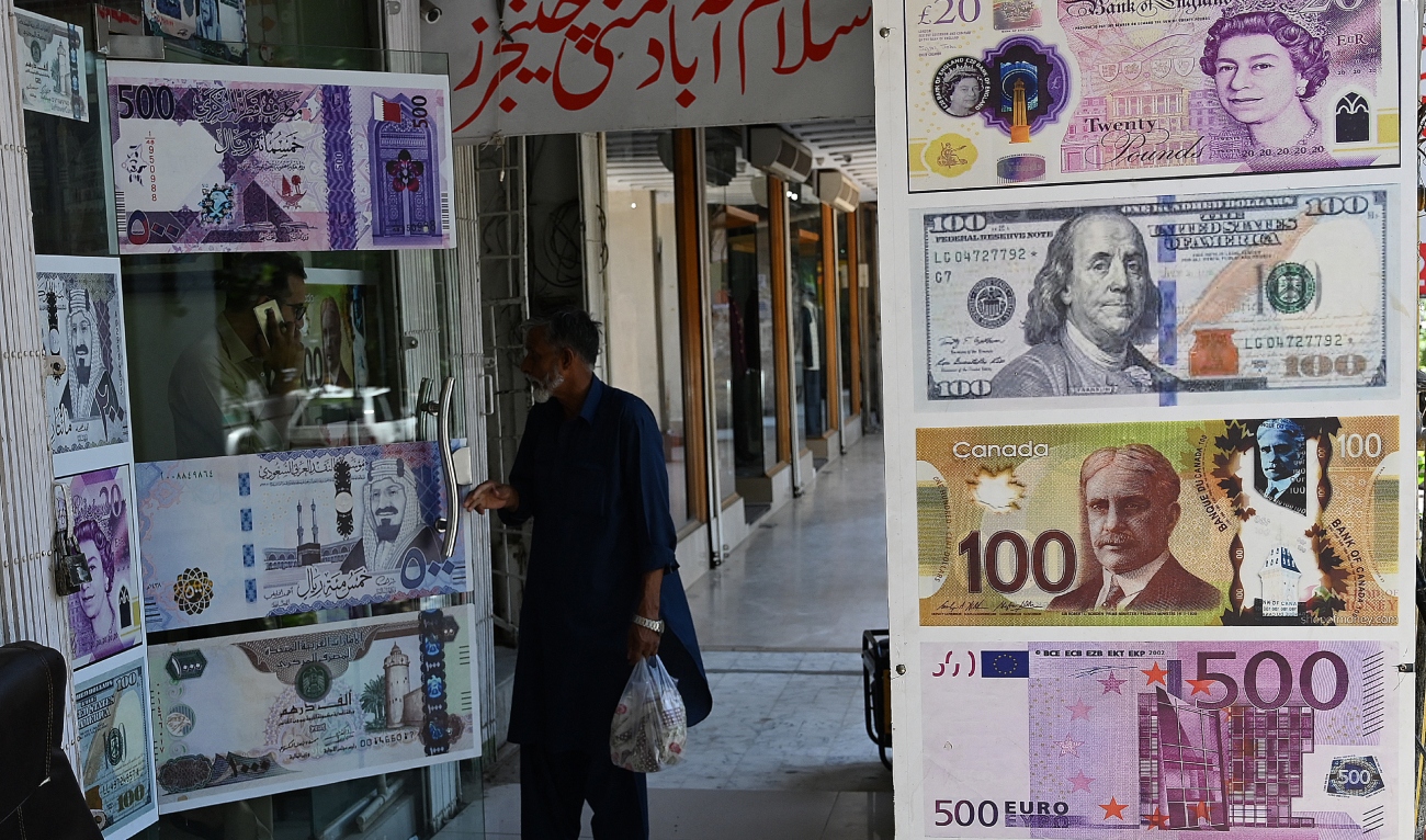 A man enters a foreign currency exchange shop in Islamabad on July 11, 2023. (AFP/File)