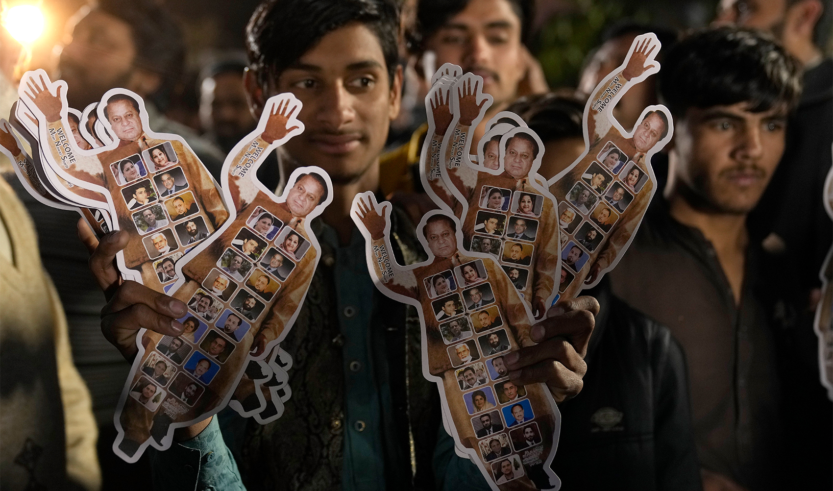A supporters of Former Prime Minister Nawaz Sharif' party 'Pakistan Muslim League-N' holds the cutouts of his leader as he with other celebrate their party victory in the initial results of the country's parliamentary election, in Lahore, Pakistan, on February 9, 2024. (AP/File)