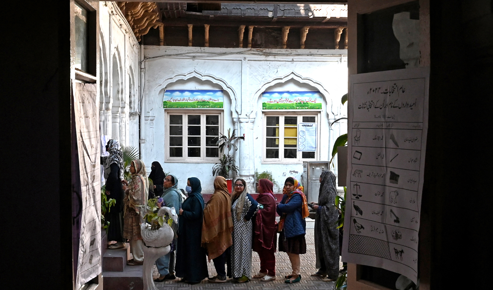 Pakistan's women wait in a queue to cast their ballots to vote at a polling station during national elections in Lahore on February 8, 2024. (AFP/File)