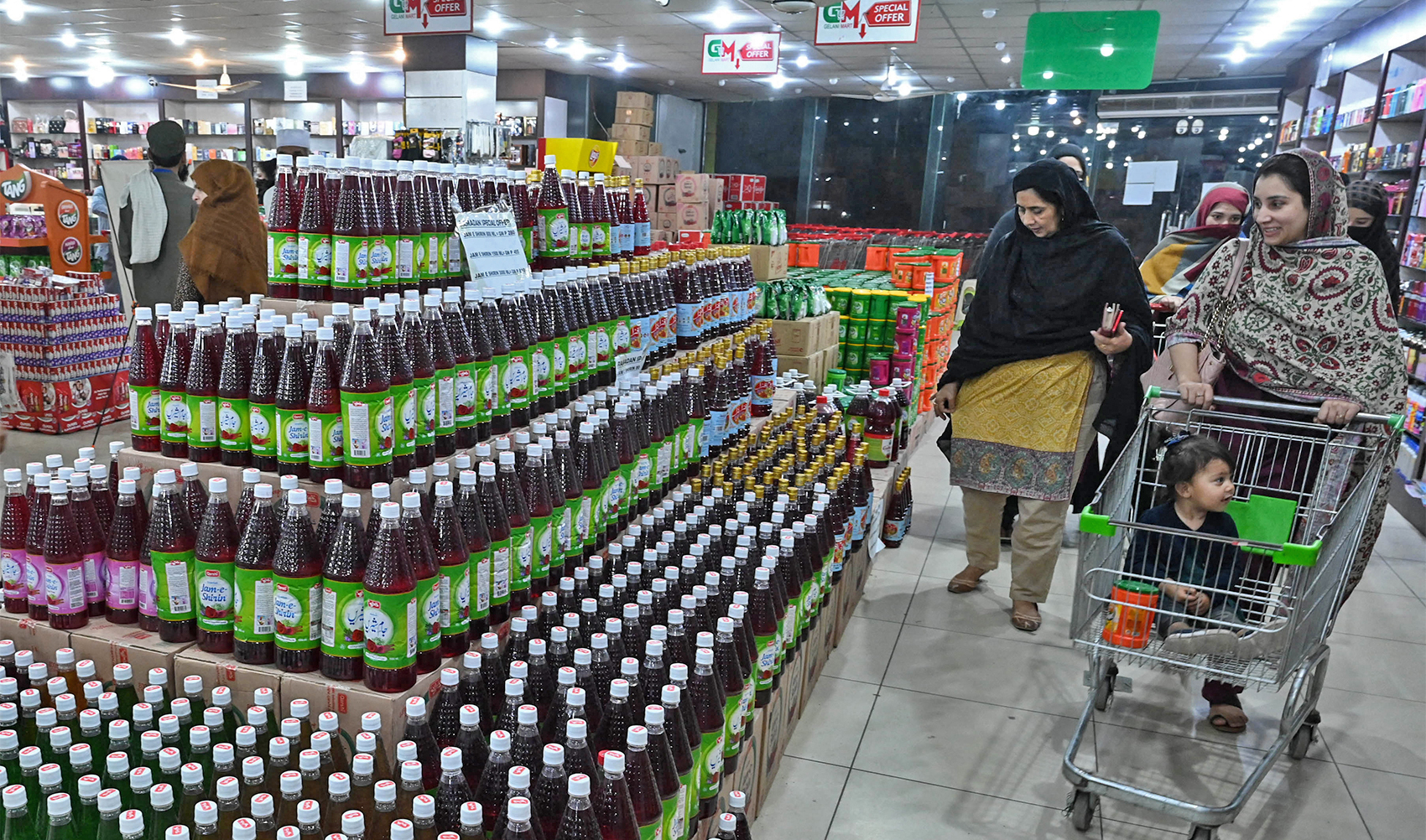 People buy food and drinks items at a store ahead of the Muslim holy fasting month of Ramadan in Peshawar, Pakistan, on March 20, 2023. (AFP/File)