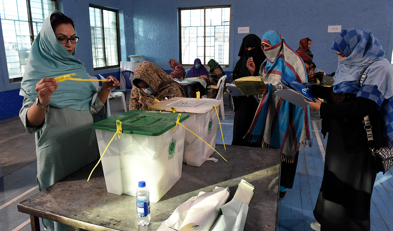 A polling staff count ballots at a polling station after polls closed, during the general election, in Lahore, Pakistan, February 8, 2024. (REUTERS)