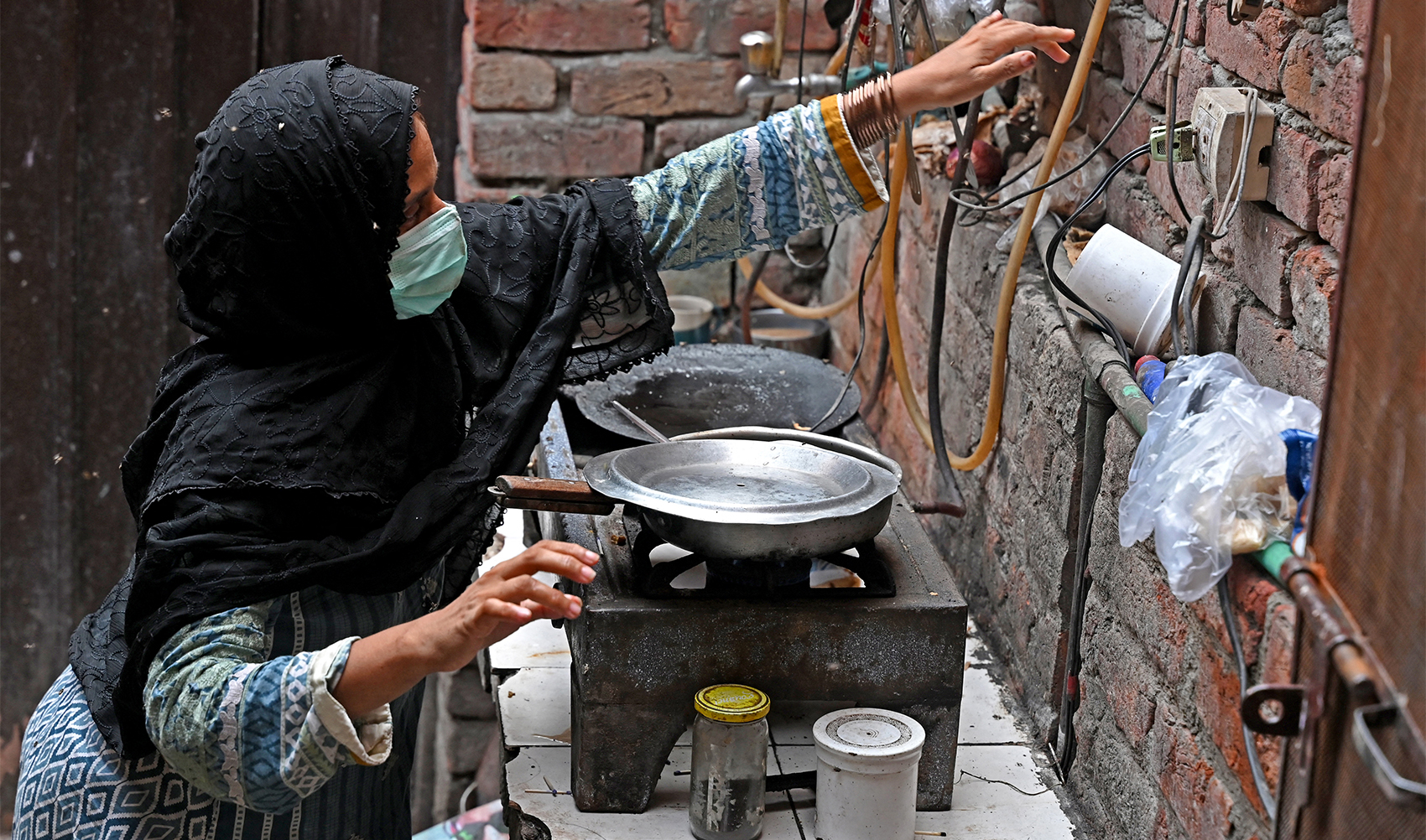 In this picture taken on July 25, 2023, a Pakistani woman cooking food at her house in Lahore. (AFP/File)