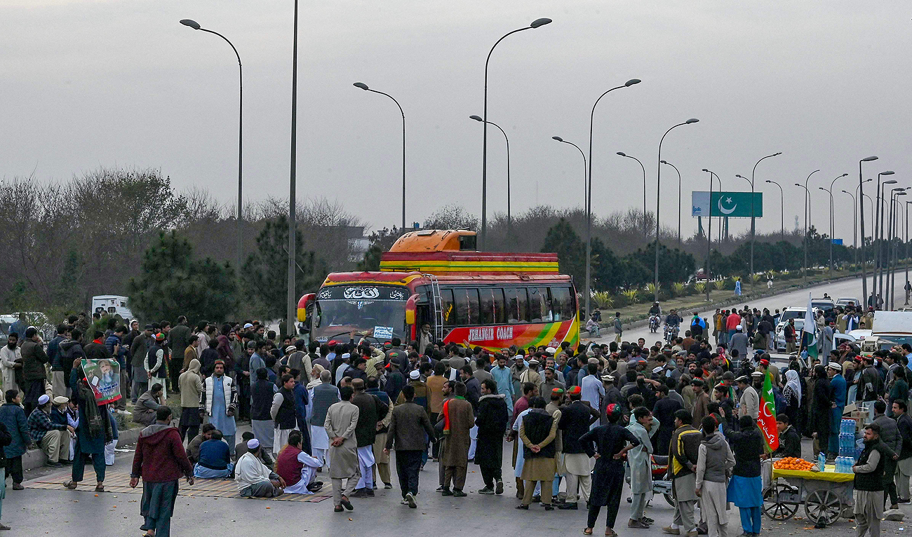 Supporters of Khan's Pakistan Tehreek-e-Insaf (PTI) party block Peshawar to Islamabad highway as they protest against the alleged skewing in Pakistan's national election results, in Peshawar on February 12, 2024. (AFP)