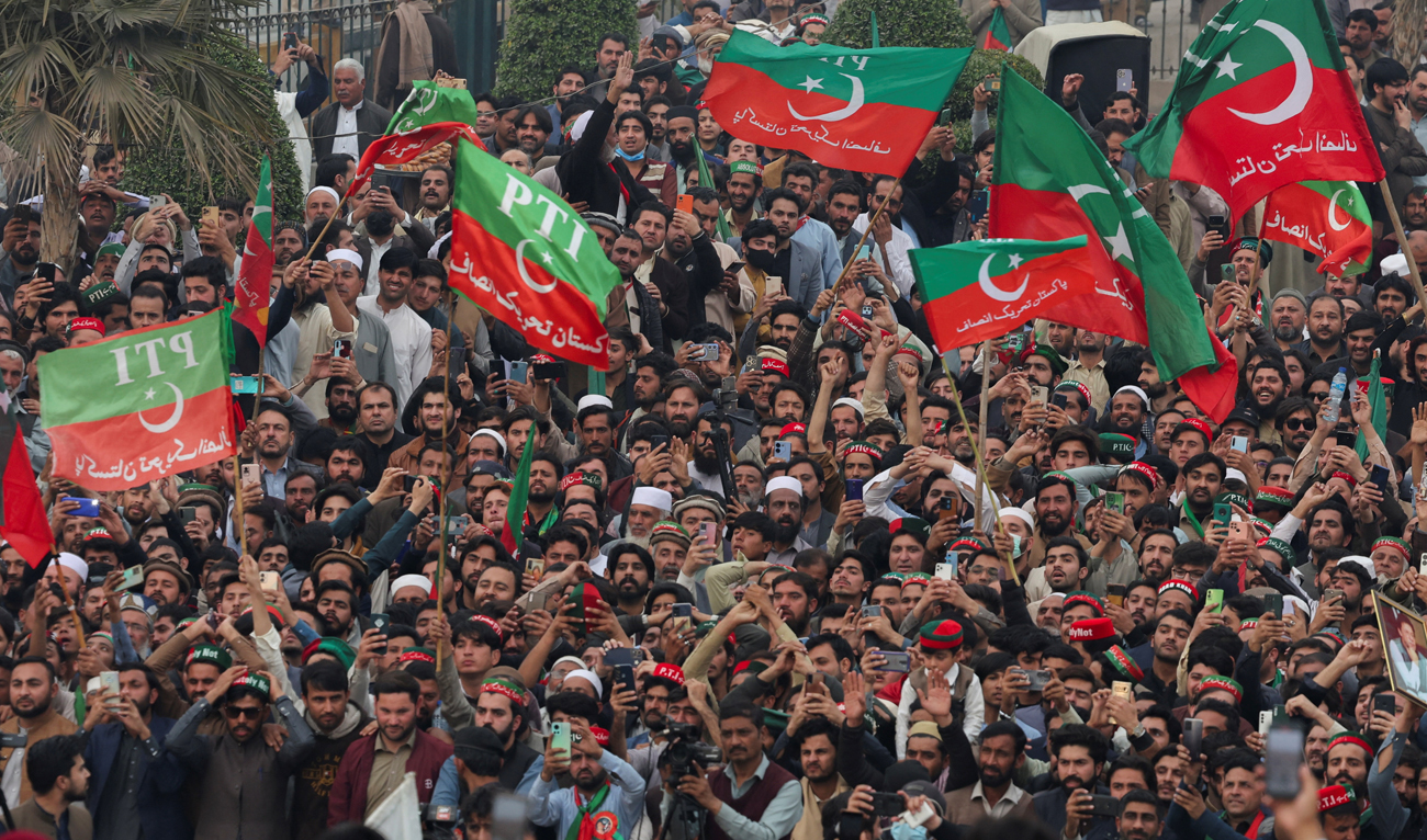 Supporters of former Prime Minister Imran Khan's party, the Pakistan Tehreek-e-Insaf (PTI), wave flags as they protest demanding free and fair results of the elections, in Peshawar on February 17, 2024. (REUTERS)