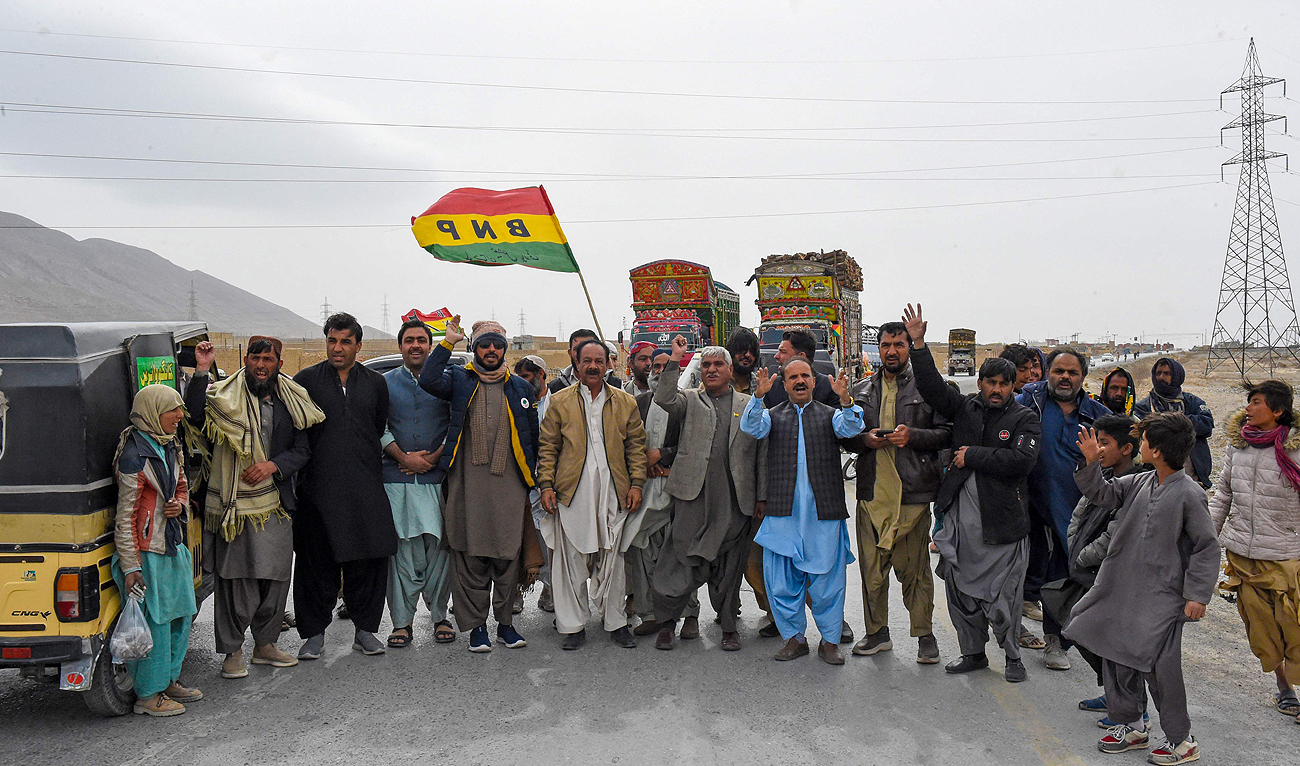 Supporters of Balochistan National Party, Pashtunkhwa Milli Awami Party and Hazara Democratic Party protest against the alleged skewing in Pakistan's national election results, as they block the Quetta-Sibi highway in Balochistan on February 18, 2024. (AFP)