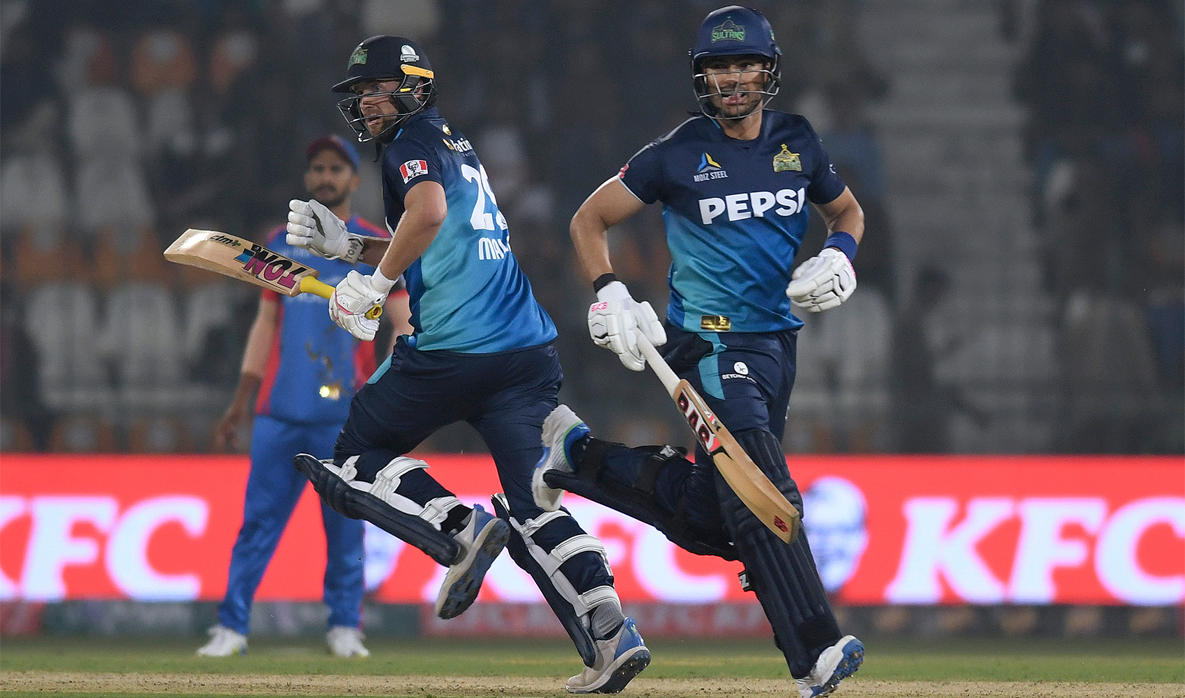 Multan Sultans' Dawid Malan, right, and Reeza Hendricks run between the wickets during the Pakistan Super League T20 cricket match between Multan Sultans and Karachi Kings in Multan, Pakistan, on February 18, 2024 (AP)