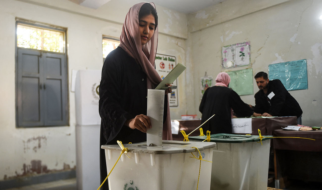 A woman cast her ballot to vote at a polling station during Pakistan's national elections in Karachi on February 8, 2024. (AFP/File)