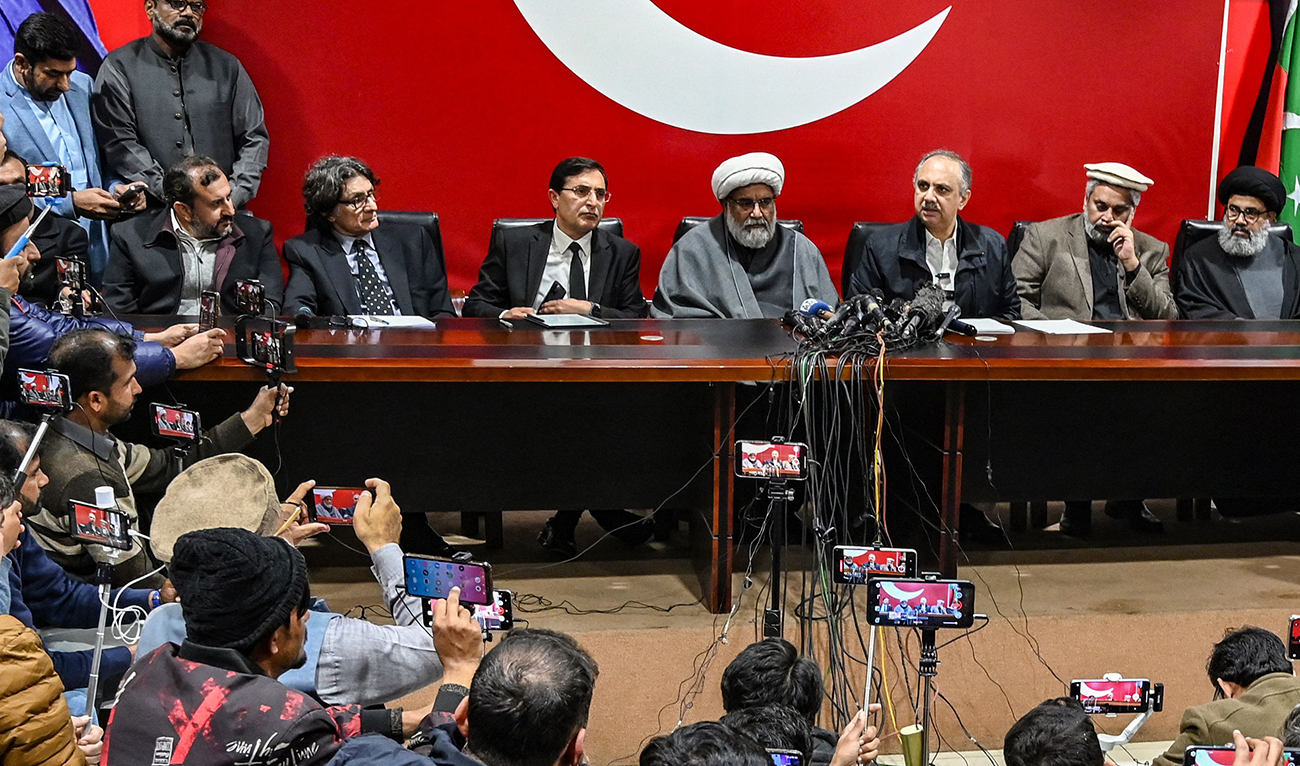 Omar Ayub Khan (4R), Pakistan Tehreek-e-Insaaf (PTI) party's nominee for prime minister speaks as Gohar Ali Khan (3L seated), PTI's chairman and barrister with Sahibzada Muhammad Hamid Raza (3R), leader of the political group Sunni Ittehad Council watches during a press conference following their coalition in Islamabad on February 19, 2024. (AFP)