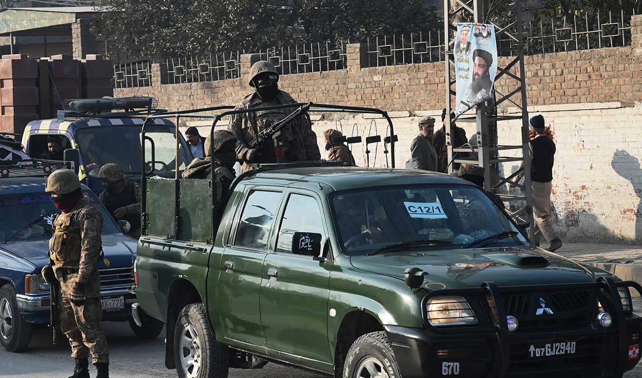 Pakistan Army personnel patrol stand guard outside a distribution center of polling materials in Peshawar on February 7, 2024. (AFP/File)