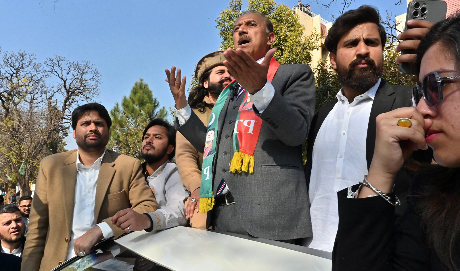 Pakistan Tehreek-e-Insaf (PTI) party spokesperson, Shoaib Shaheen (center), addresses the protesters in Islamabad on February 11, 2024, amid claims the election result delay is allowing authorities to rig the vote-counting. (AFP/File)