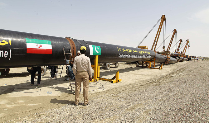 An Iranian worker stands in front of a section of a pipeline after the project was launched during a ceremony with presidents of Iran and Pakistan on March 11, 2013 in the Iranian border city of Chah Bahar. (AFP/File)