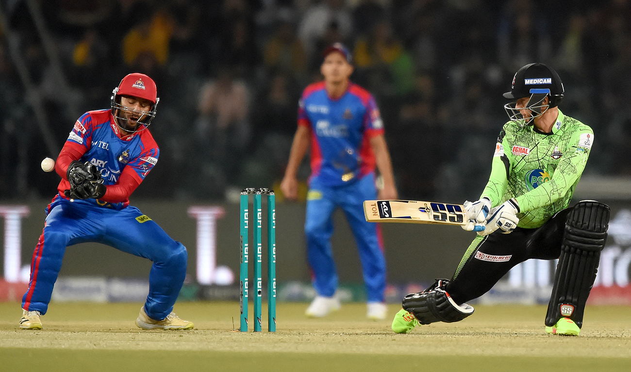 Lahore Qalandars’ Rassie van der Dussen (R) plays a shot as Karachi Kings’ wicketkeeper Muhammad Akhlaq fields during the Pakistan Super League (PSL) Twenty20 cricket match between Karachi Kings and Lahore Qalandars at the Qaddafi Cricket Stadium in Lahore on February 24, 2024. (AFP)
