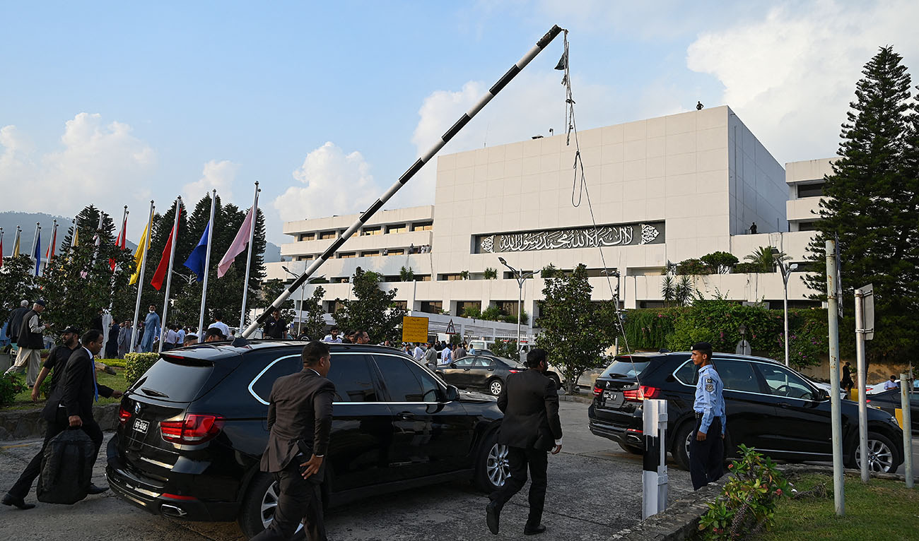 Security personnel escort a vehicle carrying Pakistan's Prime Minister Shehbaz Sharif as he leaves after attending current last session of National Assembly in Islamabad on August 9, 2023. (AFP/File)