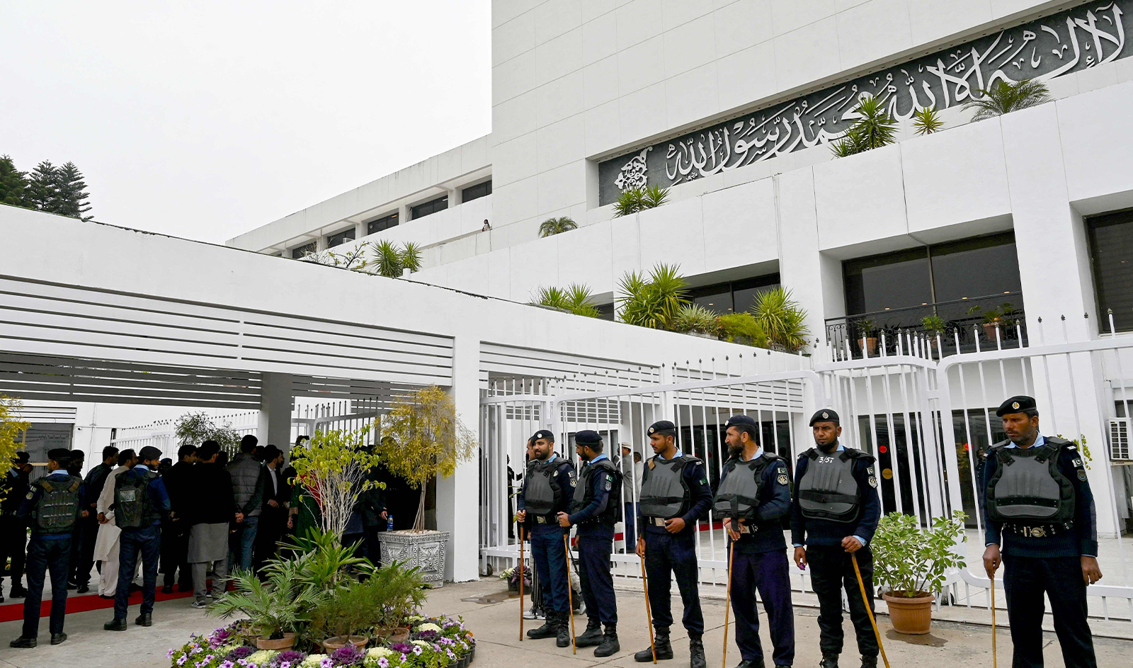 Security personnel stand guard before the start of the inaugural session of the National Assembly after general election, outside the parliament house building in Islamabad on February 29, 2024. (AFP)