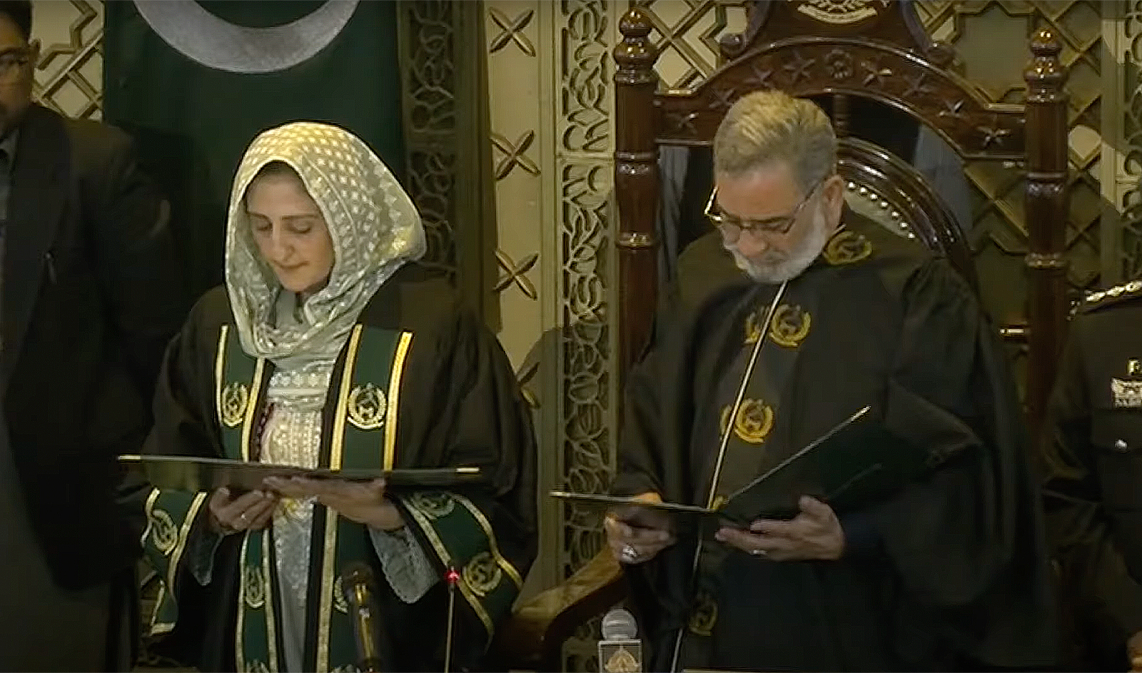 The screengrab taken from a video shared by PTI shows the newly-elected speaker of Khyber Pakhtunkhwa provincial assembly, Babar Saleem Swati (right), administering the oath to deputy speaker Suraiya Bibi in Peshawar, Pakistan, on February 29, 2024. (PTI)