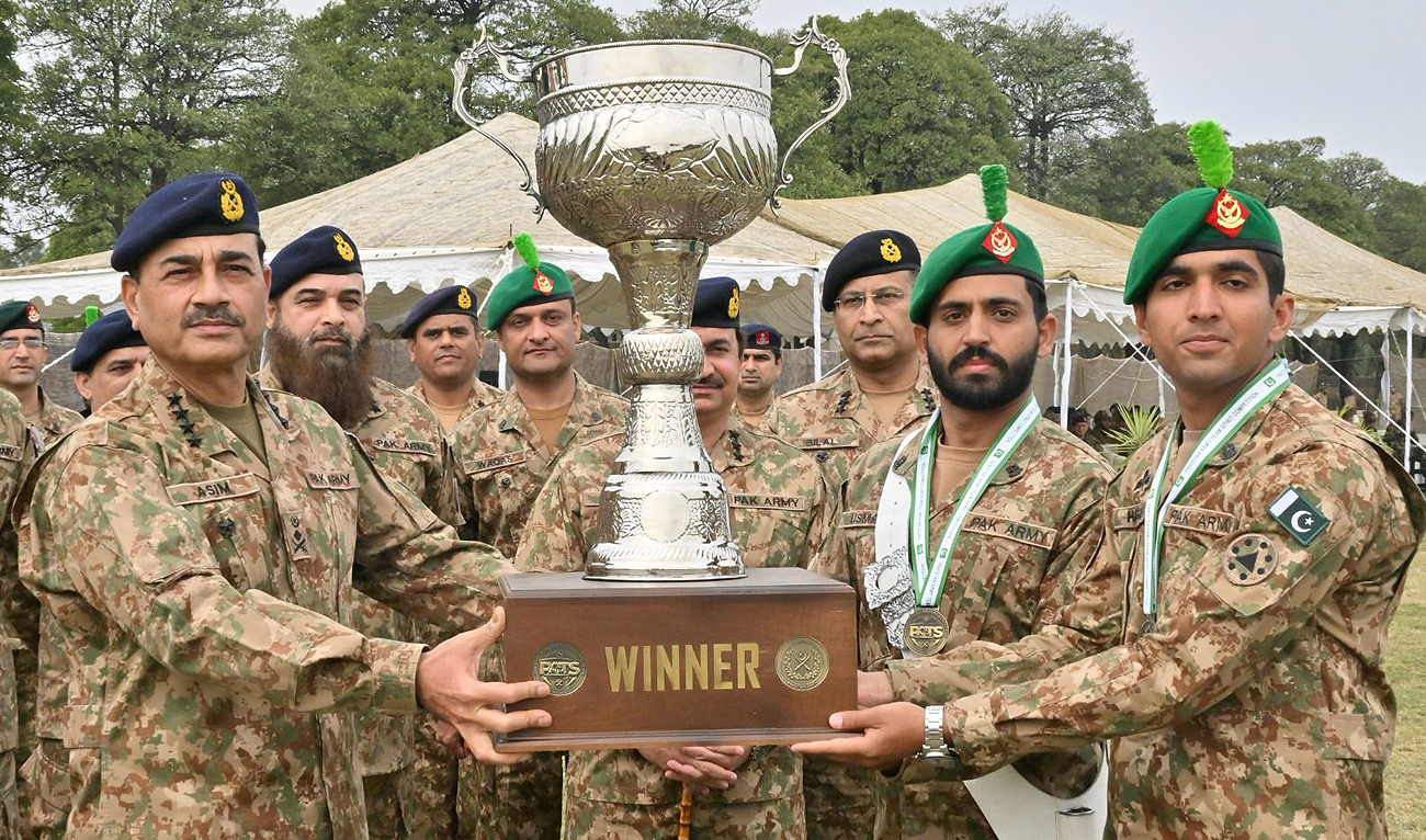 In this handout photo, taken and released by Pakistan’s Inter-Service Public Relations (ISPR), Pakistan Army Chief General Asim Munir (left) handover the trophy to the participating soldiers at the 7th International Pakistan Army Team Spirit Exercise-2024 concluding ceremony at the Garrison Academy Kharian Cantt in Gujrat, Punjab on February 29, 2024. (Photo courtesy: ISPR)