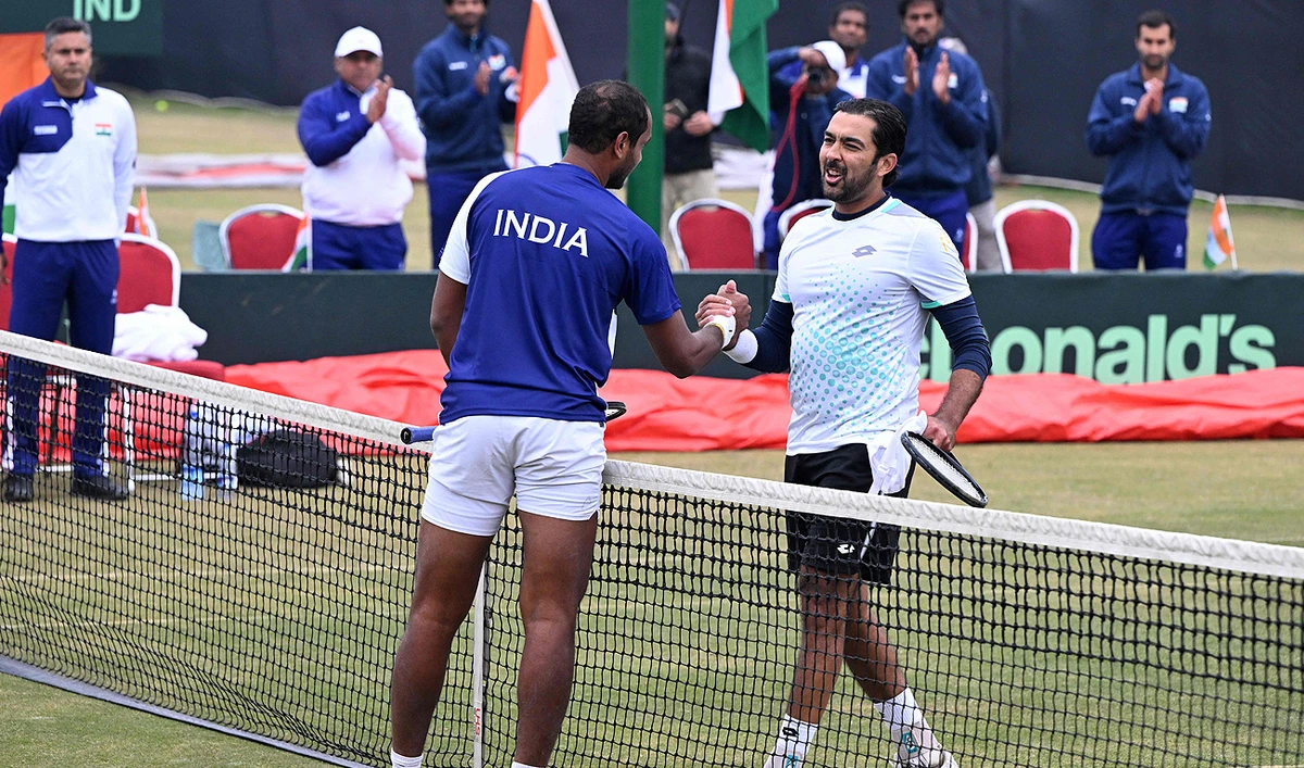 India's Ramkumar Ramanathan (L) greets Pakistan's Aisam-ul-Haq Qureshi (R) after winning the singles tennis match of the Davis Cup World Group-1 play-off between Pakistan and India, in Islamabad on February 3, 2024. (AFP)
