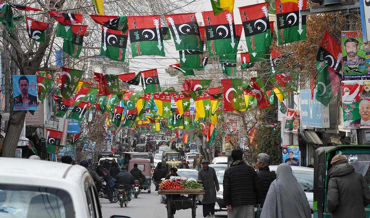 This photo taken on February 3, 2024, shows a street festooned with flags of political parties ahead of Pakistan's national elections, in Quetta. (AFP)