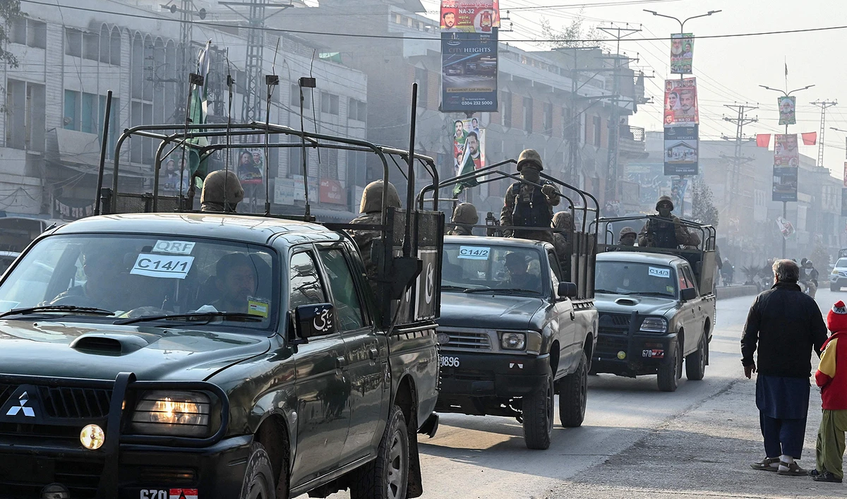 A Pakistan Army convoy patrols along a road in Peshawar on February 7, 2024, a day prior Pakistan's national elections. (AFP)