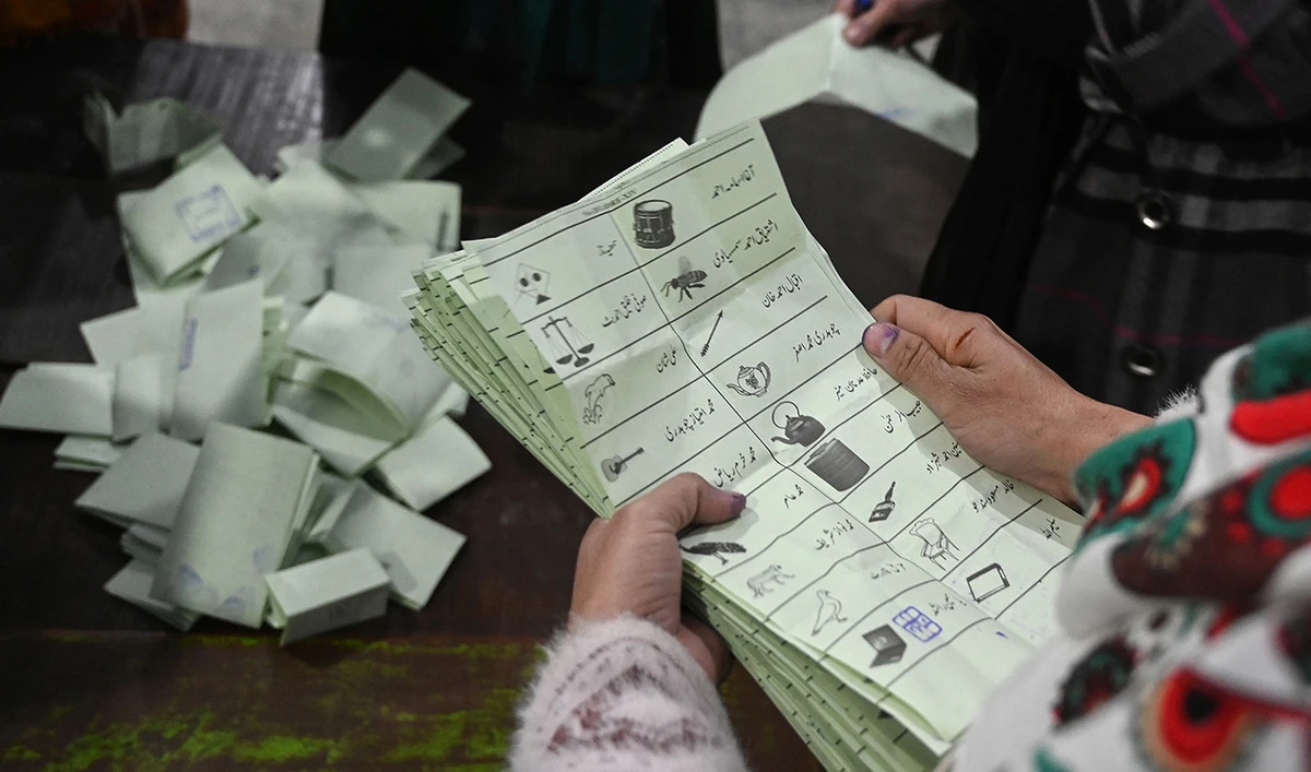 Election officials count ballot papers after polls closed at a polling station during Pakistan national election in Lahore on February 8, 2024. (AFP)