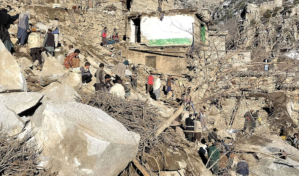Villagers and rescue personnel search for survivors amid debris in a mountainside at Nakre village in the Dara Tateen area of Noorgram district in Nuristan province on February 20, 2024, after a heavy snowfall triggered a landslide. (AFP)