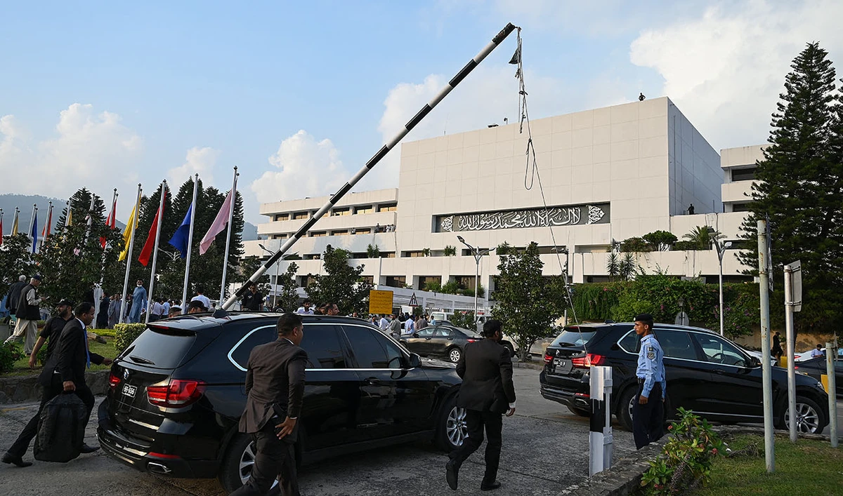 Security personnel escort a vehicle carrying Pakistan's Prime Minister Shehbaz Sharif as he leaves after attending current last session of National Assembly in Islamabad on August 9, 2023. (AFP/File)