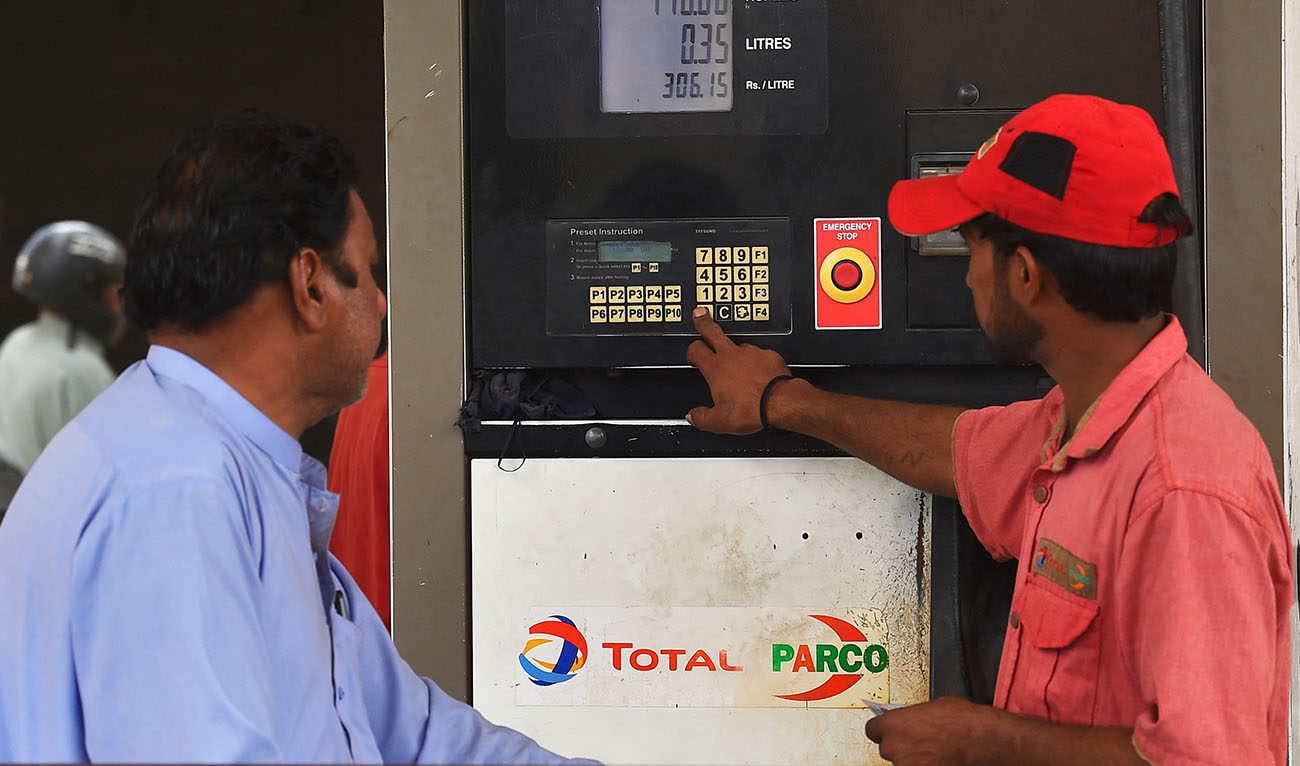 An employee prepares to fill petrol in a vehicle at a fuel station in Karachi on September 1, 2023. (AFP/File)