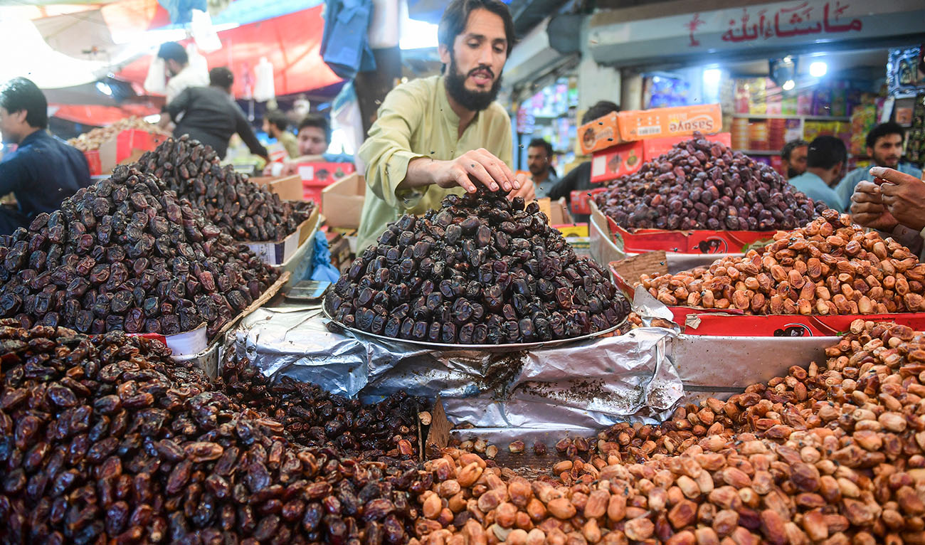 A vendor arranges dates at his stall in a market ahead of the Muslim holy fasting month of Ramadan in Karachi on March 20, 2023. (AFP/File)