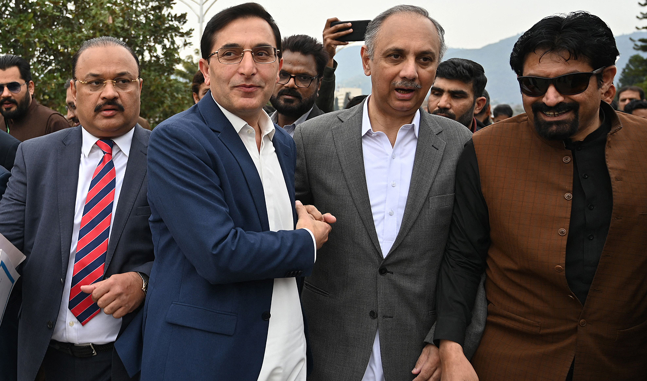 Omar Ayub Khan (3R), Pakistan Tehreek-e-Insaaf (PTI) party's nominee for prime minister and Gohar Ali Khan (3L), PTI's chairman and barrister arrive before the start of the inaugural session of the National Assembly, at the parliament house building in Islamabad on February 29, 2024. (AFP)