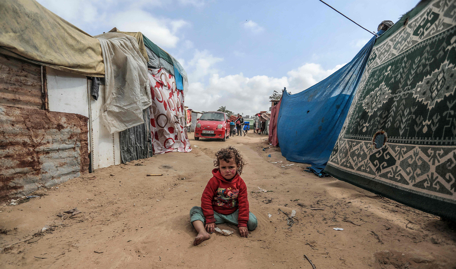 A child plays in a makeshift camp for displaced Palestinians in Deir al-Balah in central Gaza on March 3, 2024. (AFP)