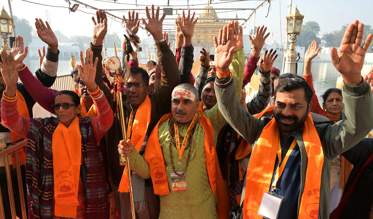 Indian Hindu pilgrims react as they leave for the Katas Raj Temple situated in Pakistan, in Amritsar on December 19, 2023. (AFP/File)